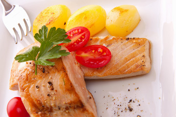 Roasted wild salmon on white plate. 