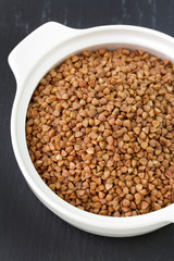 buckwheat in white bowl in dark background