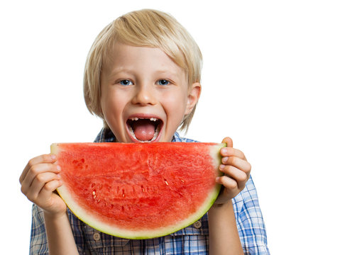 Smiling boy taking bite of water melon