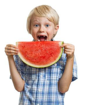 Boy taking bite of water melon