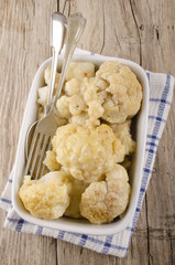 cauliflower with melted cheese in a bowl