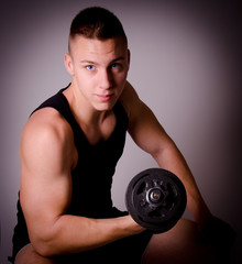 Fitness man with dumbbell.