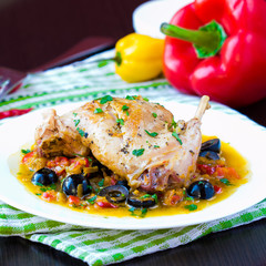Ragout from stewed legs of rabbit with herbs, vegetables, olive
