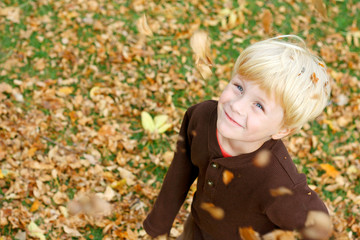 Happy Child in Falling Leaves