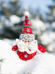 santa toy in snowdrift with snow