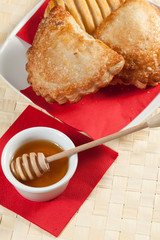 Breakfast including bread and honey.