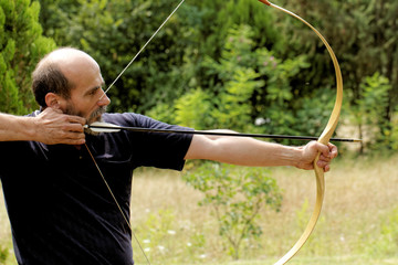man shooting with bow