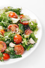 Fresh vegetable salad with tomato, cucumber, feta and greens