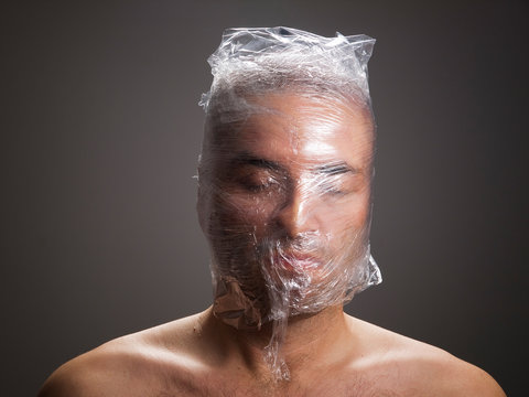 Man suffocating with plastic around his head