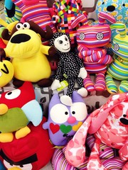 Fototapeta na wymiar many colored toys background, multi coloured children background, playing toys, top sail, toys sail, kids shop, funny toys