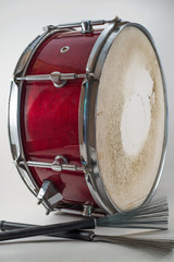 Red Wooden snare drum and Jazz brushes isolated