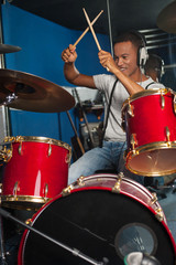 Cheerful musician playing drums