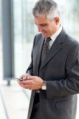 senior businessman texting