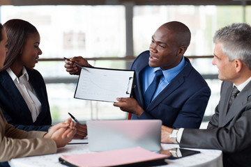 young african american businessman presenting figures at a meeti