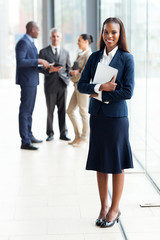 african businesswoman standing in modern office