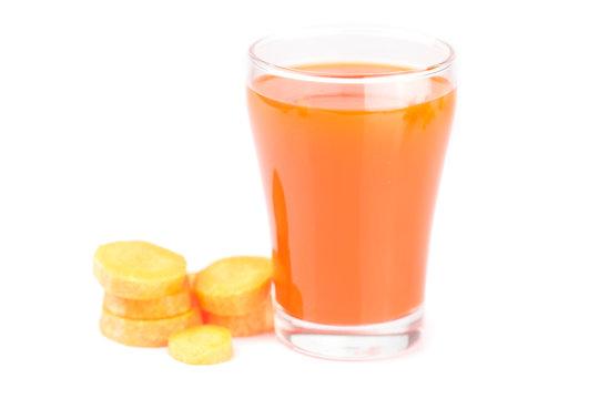 carrot and a glass of carrot juice isolated on white