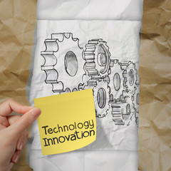 hand holding innovation on sticky note with gear to success conc