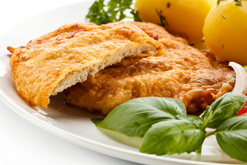 Fried pork chops, boiled potatoes and vegetable salad