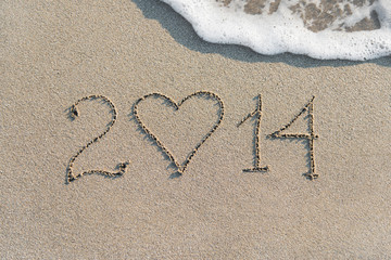 Happy New Year 2014 on the sea sandy beach with heart, love conc