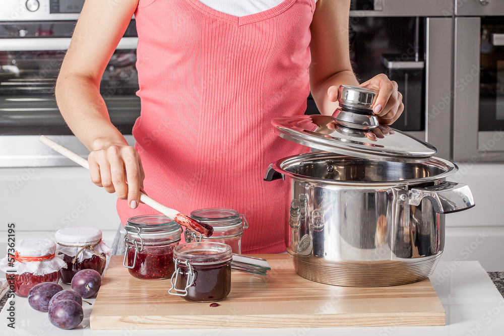 Wall mural housewife preparing plum jams