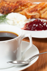 Light meal with coffee, bread and jam.