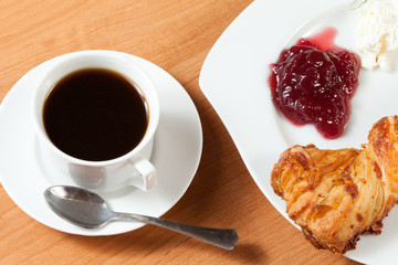 Light meal with coffee, bread and jam.