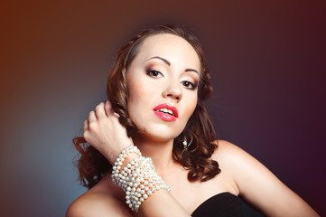 Portrait of a beautiful young woman with pearl bracelet