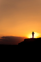 Fototapeta premium Silhouette of hiking woman with backpack