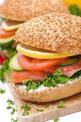 burger with smoked salmon and vegetables, close-up