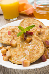 homemade pancakes with peaches and honey for breakfast, close-up