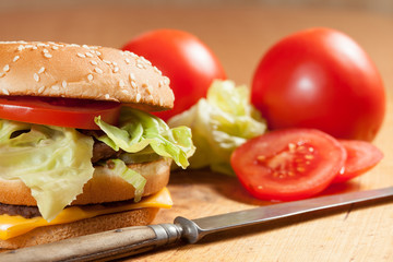 Delicious hamburgers on a wooden table.