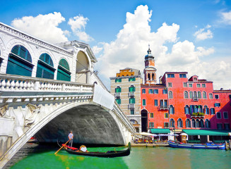 Famous Ponte di Rialto with Gondola in Venice, Italy