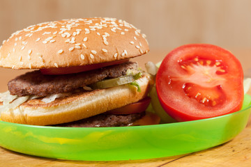 Delicious hamburgers on a wooden table.