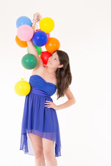 Fototapeta na wymiar Young girl with balloons on a white background