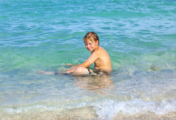 boy enjoys the clear water in the ocean