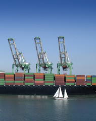 Fototapeta premium Cargo ship and sailboat