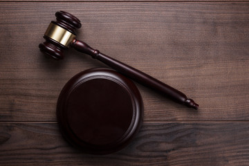 judge gavel on brown wooden background