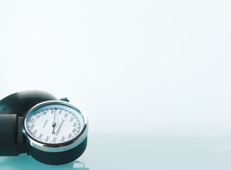 Sphygmomanometer on blue, reflective background