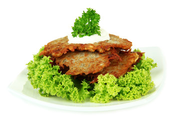 Potato pancakes on plate, isolated on white