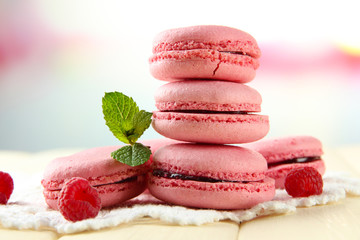Gentle macaroons on table on light background