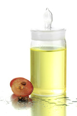 Ripe sliced grape and grapeseed oil, isolated on white