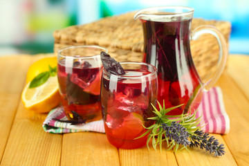 Red basil lemonade in jug and glass,