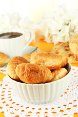 Tasty croissants and cup of coffee on table close-up