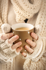 Female hands with hot drink, close-up