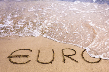 Euro word written in the sand on a beach, washed away by sea