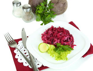 Beet salad on plate on napkins isolated on white