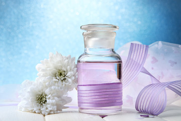 Glass bottles with color essence, on light background