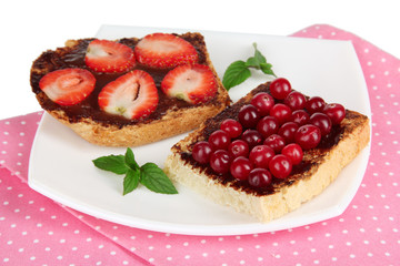 Delicious toast with berries on plate close-up
