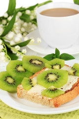 Delicious toast with kiwi on table close-up