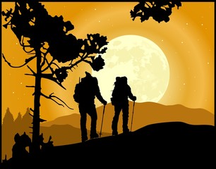 Two climbers in silhouette climbing the mountain